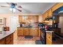 Cozy kitchen with warm wood cabinets, granite countertops, and black appliances at 8506 Old Nichols Hwy., Nichols, SC 29581