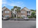 Beautiful condo building with brick facade, screened porches, and well-maintained landscaping at 9 Pistachio Loop # D, Murrells Inlet, SC 29576