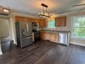 Stylish kitchen featuring stainless steel appliances, wooden cabinetry, and modern lighting fixtures at 1041 Morning Dale St., Conway, SC 29526