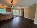 Well-lit kitchen with wooden cabinets, stainless steel appliances, and windows above the sink at 1041 Morning Dale St., Conway, SC 29526