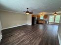Spacious living room with hardwood floors, ceiling fans, and an open layout to the kitchen at 1041 Morning Dale St., Conway, SC 29526