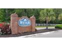 Elegant brick community sign for Weslin Creek with lush landscaping and a charming aesthetic at 1089 Weslin Creek Dr., Myrtle Beach, SC 29588
