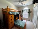This bedroom features a wooden bunkbed with built-in drawers and desk, perfect for maximizing space and functionality at 1101 Peace Pipe Pl. # 104, Myrtle Beach, SC 29579