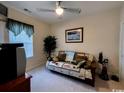 Cozy bedroom features a neutral palette, ceiling fan, and comfortable furnishings for a relaxing atmosphere at 1101 Peace Pipe Pl. # 104, Myrtle Beach, SC 29579
