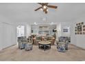 A spacious living room with plush seating, neutral carpet, ceiling fan, and access to other living spaces at 1125 Camellia Dr., Surfside Beach, SC 29575