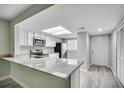 Kitchen with white cabinets, stainless steel appliances, and a breakfast bar with granite countertop at 1200 5Th Ave. N # 1207, Surfside Beach, SC 29575