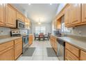 Well-lit kitchen featuring light wood cabinets, stainless steel appliances, and tile flooring at 1200 Bergen Dr., Loris, SC 29569