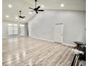 Large, bright living room with vaulted ceilings, a ceiling fan, recessed lights and attractive, easy care floors at 126 Clovis Circle, Myrtle Beach, SC 29579
