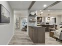 Inviting open-concept living space with wood-look floors, beam ceilings, and modern decor at 1325 Rabbit Ln., Conway, SC 29526