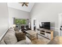 Bright living room features high ceilings, neutral tones, and access to a private balcony at 1356 Glenns Bay Rd. # A202, Surfside Beach, SC 29575