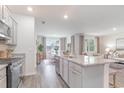 Open kitchen design with a center island, granite countertops, and view into living and dining spaces at 1371 Nokota Dr., Conway, SC 29526