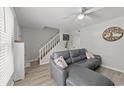 Inviting living room boasts stylish sofa, complemented by staircase, and neutral color palette at 1409 Highway 15 # 4, Myrtle Beach, SC 29577
