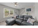 Bright living room showcases large window, comfortable sofa, staircase, and neutral décor at 1409 Highway 15 # 4, Myrtle Beach, SC 29577