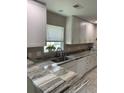 Bright kitchen featuring granite counters, white cabinets, and modern appliances at 1432 Seahouse Ct., Surfside Beach, SC 29575