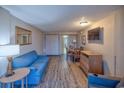 Inviting living room with blue sofa, dining space, and entertainment area at 1501 Ocean Blvd. S # 242, Myrtle Beach, SC 29577