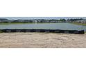 Scenic view of a community pond, with a fountain, surrounded by neighborhood homes and landscaping at 1531 Breakwater Dr., Little River, SC 29566