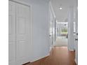 Bright hallway with hardwood floors and white doors, leading to an open-concept living area with natural light at 1551 Spinnaker Dr. # 5312, North Myrtle Beach, SC 29582