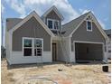 Charming home with grey siding, crisp white trim, and a welcoming covered entry at 1559 Breakwater Dr., Little River, SC 29566