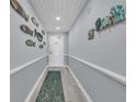 Hallway decorated with charming nautical-themed decor leading to the front door at 1625 S Ocean Blvd. # 211, North Myrtle Beach, SC 29582