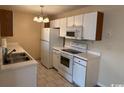 Bright kitchen featuring tile flooring, laminate countertops and white appliances at 1980 Bent Grass Dr. # F, Surfside Beach, SC 29575