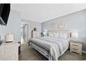 Bright bedroom with coastal decor featuring a queen bed, soft blue walls and stylish furnishings at 2001 S Ocean Blvd. # 815, Myrtle Beach, SC 29577