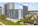 Exterior view of a resort property featuring a refreshing outdoor pool and well-maintained grounds at 2001 S Ocean Blvd. # 815, Myrtle Beach, SC 29577