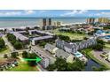 An aerial view of the condo with the ocean view and adjacent buildings at 211 N Hillside Dr. # 204, North Myrtle Beach, SC 29582