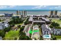 Aerial view of building with ocean views, adjacent buildings, and landscaping at 211 N Hillside Dr. # 204, North Myrtle Beach, SC 29582