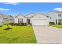 Home exterior features driveway, a one car garage, manicured lawn, and neat landscaping at 211 Pine Forest Dr., Conway, SC 29526