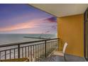 A condo balcony overlooks the beach with seating and a table to enjoy the gorgeous views at 2600 N Ocean Blvd. # 1406, Myrtle Beach, SC 29577