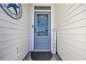 Close-up of a stylish front door with decorative glass and nautical-themed accents for a welcoming entrance at 2653 Orion Loop, Myrtle Beach, SC 29577