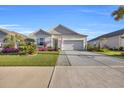 Attractive single-story home with a decorative driveway, lush landscaping, and an attached garage at 2653 Orion Loop, Myrtle Beach, SC 29577