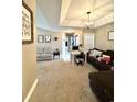 Open living room with carpet flooring, neutral walls, a ceiling fan, and a view of the hallway at 2707 Canvasback Trail, Myrtle Beach, SC 29588