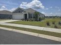 Charming single-story home with a well-manicured lawn and attached two-car garage in a residential community at 297 Harvest Ridge Way, Conway, SC 29527
