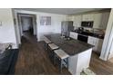 Modern kitchen with a large island, stainless steel appliances, white cabinets, and hard surface countertops at 297 Harvest Ridge Way, Conway, SC 29527