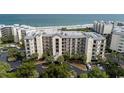 Exterior of a multi-story condo building with palm trees and well-maintained grounds at 341 South Dunes Dr. # C-34, Pawleys Island, SC 29585