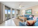 Bright living room featuring tile floors, a ceiling fan and ocean view balcony access at 341 South Dunes Dr. # C-34, Pawleys Island, SC 29585