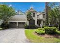 Inviting two-story home with a two car garage and a well-maintained landscaped yard at 346 Tuckers Rd. # A, Pawleys Island, SC 29585