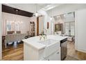Bright kitchen with hardwood floors, white cabinets, stainless steel appliances, and white countertops at 346 Tuckers Rd. # A, Pawleys Island, SC 29585