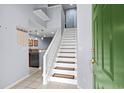Foyer with white staircase, green front door, light tile and kitchen view at 3833 Myrtle Pointe Dr. # 18 Bu 3, Myrtle Beach, SC 29577