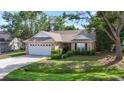 Charming brick home featuring an attached garage and manicured landscaping at 4196 Ravenwood Dr., Little River, SC 29566