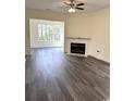 Inviting living room with a cozy fireplace and natural light from large windows at 4333 Oakwood Circle, Little River, SC 29566