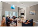Spacious living area boasting a stone fireplace, large windows, and stylish blue and orange furnishings at 4378 Willoughby Ln. # 4378, Myrtle Beach, SC 29577