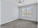 Bedroom featuring a neutral carpet, a large window, and ceiling fan at 4840 Moss Creek Loop # 38, Murrells Inlet, SC 29576