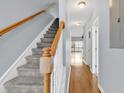 Bright hallway features hardwood floors, staircase with wooden handrail, and neutral walls at 4840 Moss Creek Loop # 38, Murrells Inlet, SC 29576