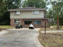An exterior view of a two-story home with brick and siding, featuring a golf cart at 4909 Yaupon Circle, Myrtle Beach, SC 29575