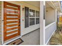 Close-up of a modern front door with glass inserts and dark hardware, complemented by a 'Welcome' mat at 5031 Medieval Dr., Conway, SC 29526