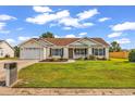 Beautiful single-story home with an attached garage, landscaped front yard, and cozy porch at 5031 Medieval Dr., Conway, SC 29526