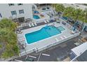 Aerial view of the large outdoor pool, showing lounge chairs, tables, and fenced perimeter at 5409 N Ocean Blvd. # 100, North Myrtle Beach, SC 29582