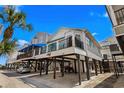 Beautiful elevated beach home offering ample covered parking, outdoor living space, and coastal charm at 6001 - 1082 S Kings Hwy., Myrtle Beach, SC 29575